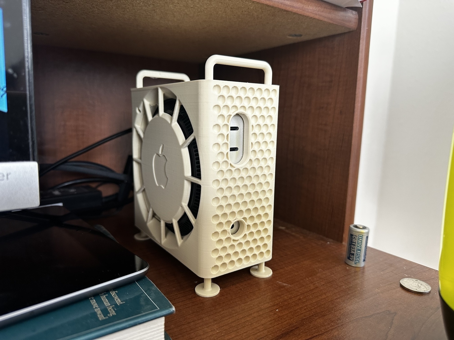 A 3D printed little Mac Pro looking case that has a Mac Mini M4 inside of it.